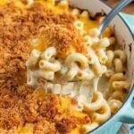 Tini's Mac and Cheese Recipe served in a light blue casserole dish, featuring creamy, cheesy macaroni with a crispy, golden breadcrumb topping. A comforting and delicious homemade baked mac and cheese dish.