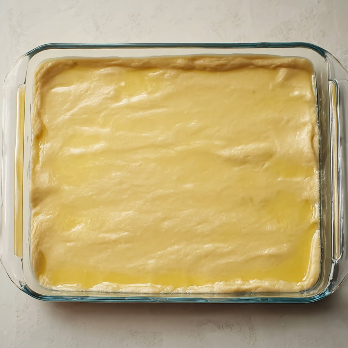 Open one tube of crescent roll dough and unroll it. Press all the seams together so you have one solid rectangle. Lay it in the pan and press it out to cover the entire bottom. It doesn't have to be perfect. Just get it mostly even.