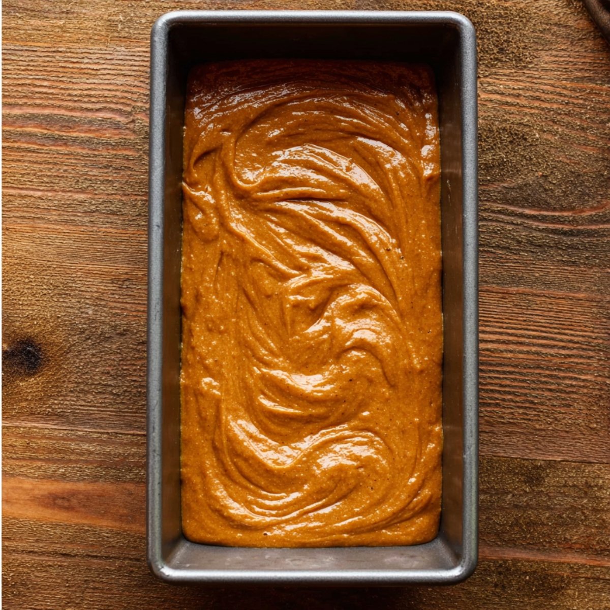 Pumpkin bread batter in a loaf pan, ready for baking