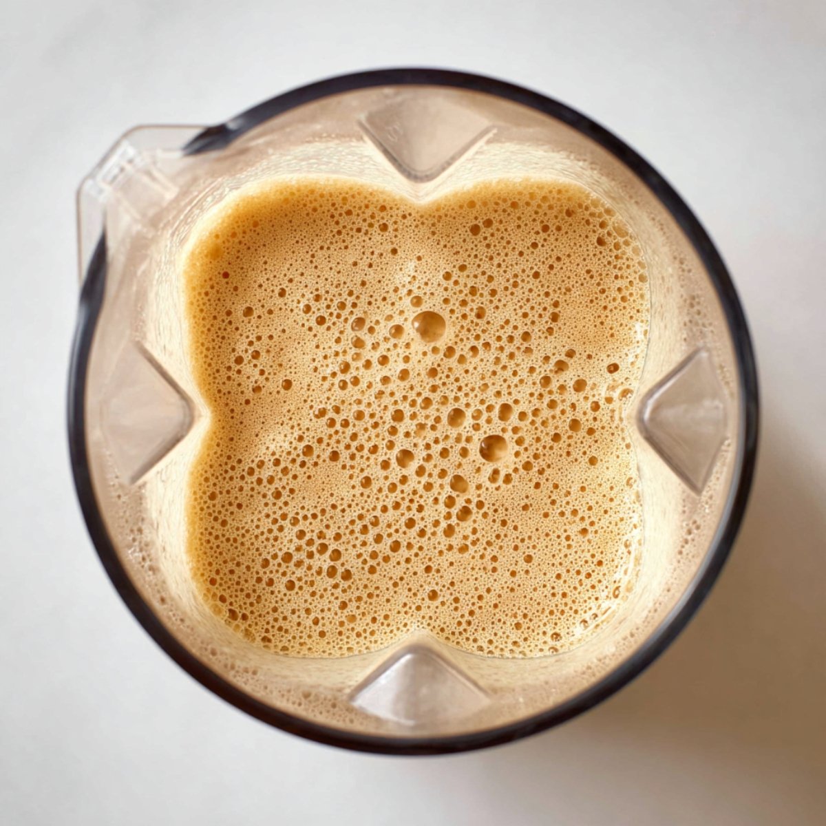 Add the pumpkin puree, pumpkin spice, maple syrup, milk, and espresso to your blender. Blend for 10 to 15 seconds until the mixture looks completely smooth and the pumpkin is fully incorporated. You'll see it turn a beautiful light orange color.