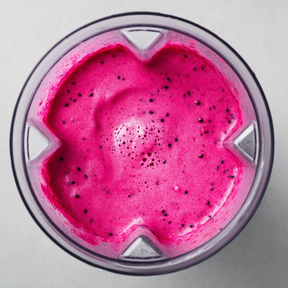 Start on low speed and work your way up to high. Blend for about 30 to 45 seconds, or until everything is completely smooth and creamy. If it's too thick, add a splash more almond milk. If it's too thin, toss in a few more frozen dragon fruit cubes.