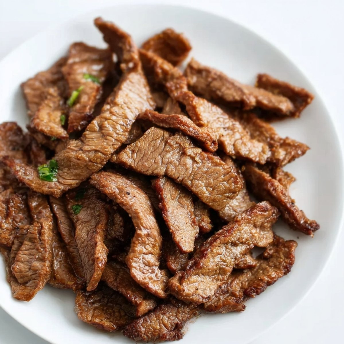 Transfer the cooked steak to a plate and let it rest.