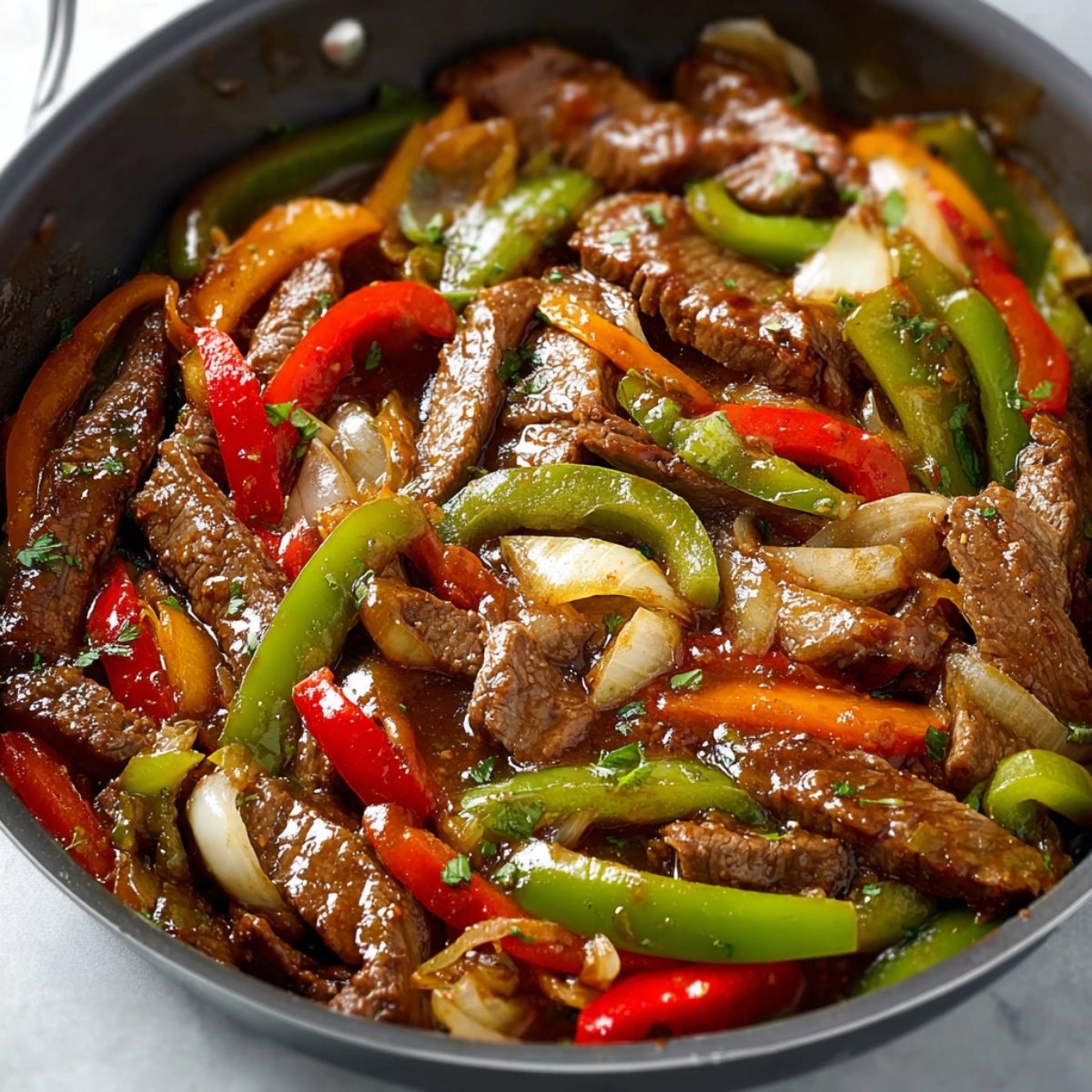 Add the cooked steak back into the pan, stirring everything together so the beef gets coated in that beautiful sauce. Let it heat through for a minute or two. Serve it immediately over warm rice or vegetable fried rice, and watch it disappear
