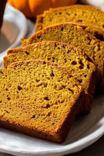 Freshly sliced Moist Pumpkin Bread served on a plate.