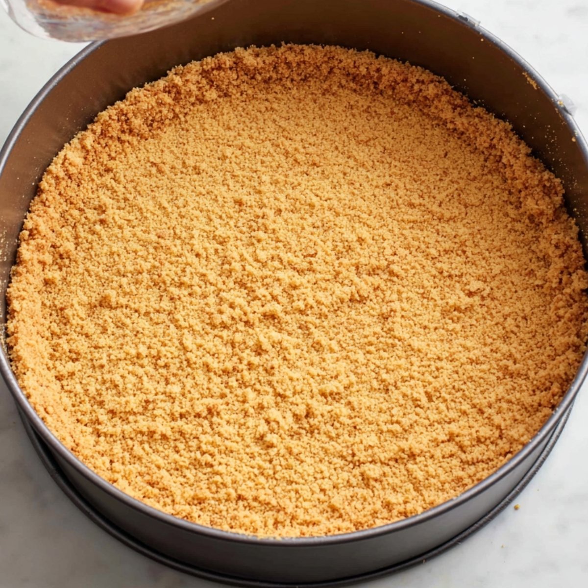 Press the crust mixture into the bottom and about 1 inch up the sides of the pan. Use a flat-bottomed glass to pack it down evenly. Set the pan on a rimmed baking sheet and bake for 12 to 14 minutes, until it smells toasty and the edges turn golden. Let it cool completely while you make the filling.