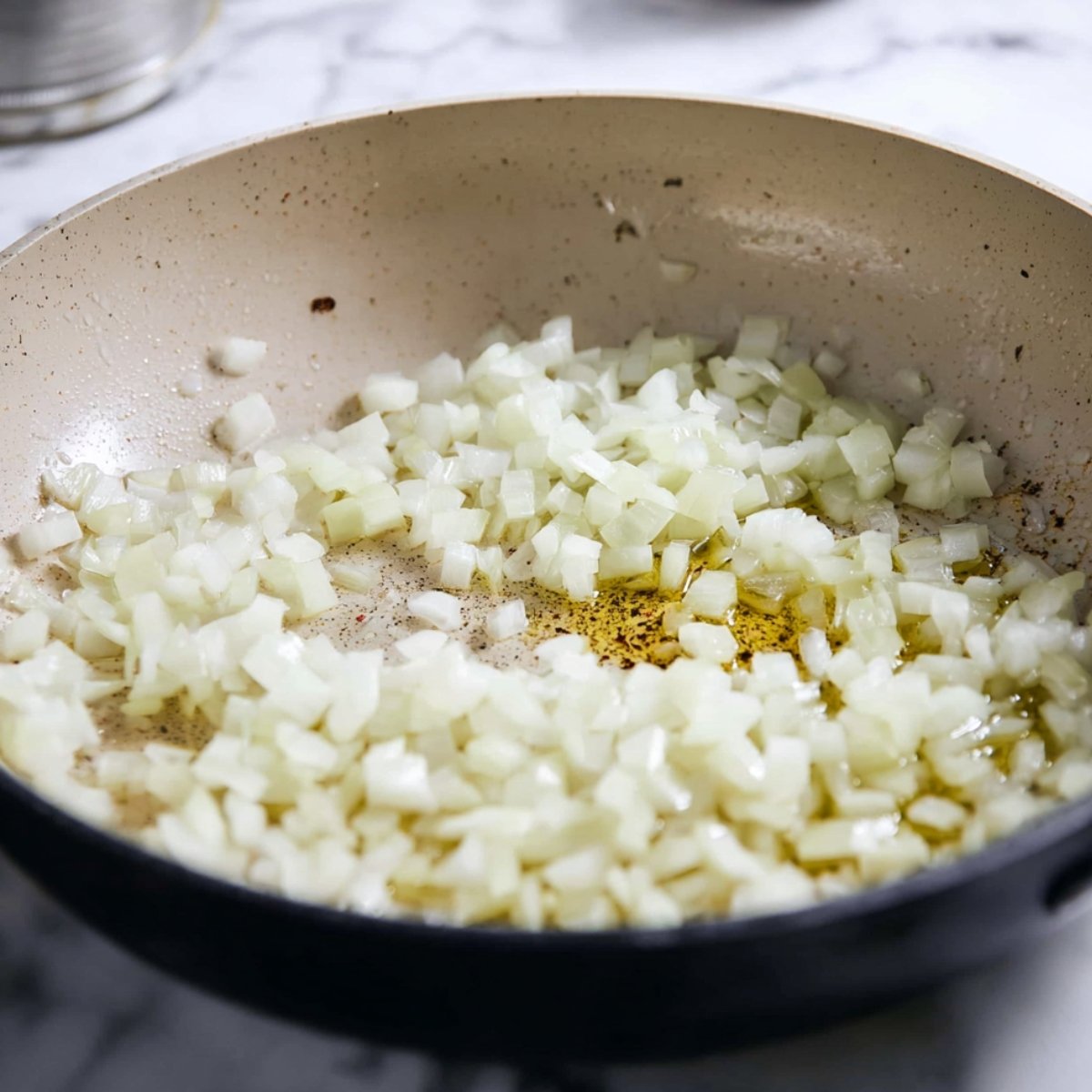 Heat the olive oil in a large 5 to 6 quart pot over medium-high heat. Add the chopped onion and cook for about 4 minutes, stirring occasionally, until it softens and turns translucent. Toss in the minced garlic and cook for just 30 seconds until you can smell it getting fragrant.