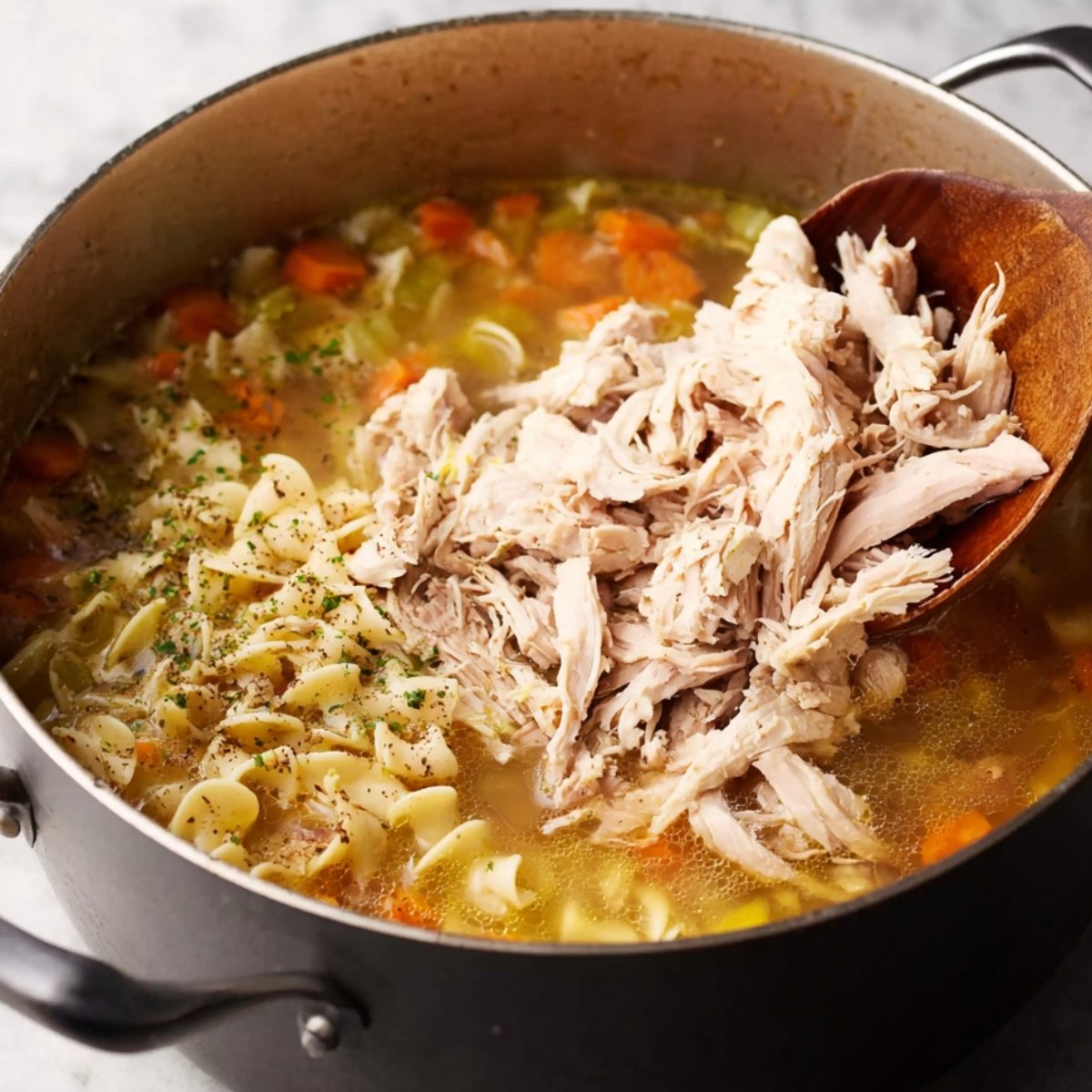 Add the shredded rotisserie chicken and stir gently until it's heated through. Taste the soup one more time and add more salt, pepper, or bouillon if needed.