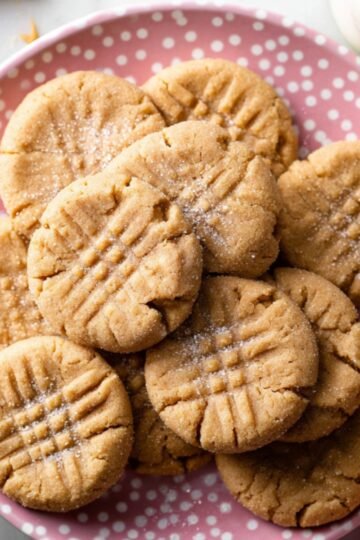 Stack of Peanut Butter Cookies on a pink plate.