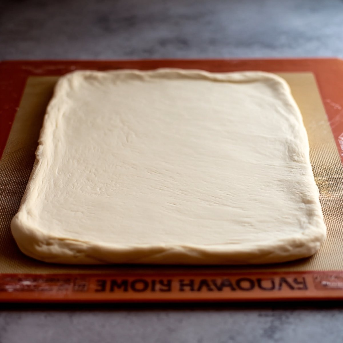 Rolled out croissant dough in a rectangular shape, ready for butter folding.