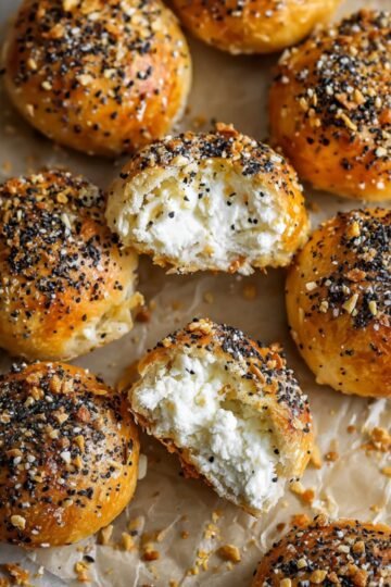 Another view of Stuffed Bagel Bites with melted cream cheese inside, topped with everything bagel seasoning.